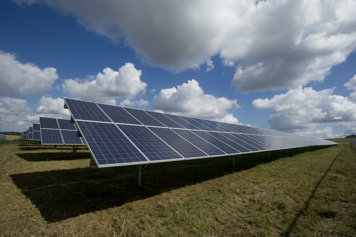 Field of solar panels under open sky