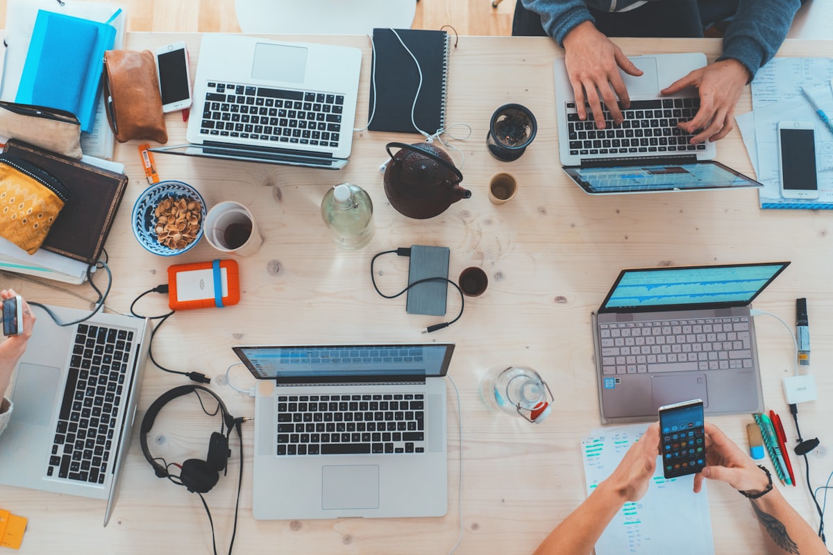 Laptops and notebooks on a shared work table